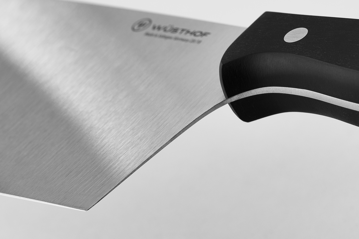 8" Chinese Chef's Knife with a polished forged stainless steel blade and a sturdy black triple-riveted handle for balanced control and precision cutting.