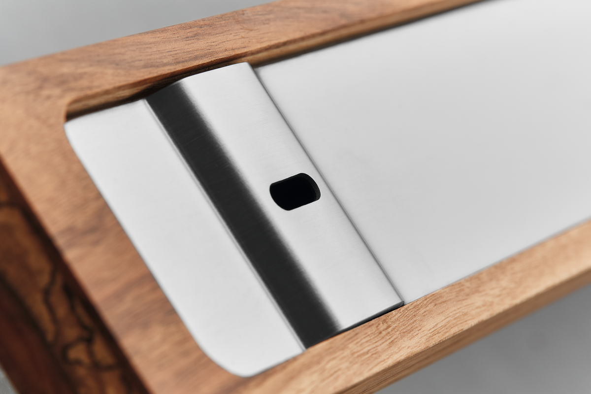 Close-up of brushed stainless steel magnetic strip mounted in natural wood frame of the 12" Wooden Magnetic Holder for kitchen knife storage.