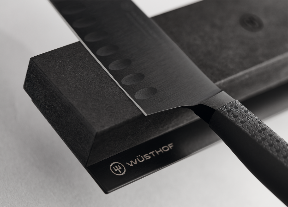16" Magnetic Holder in matte black with embossed WÜSTHOF logo, designed to securely hold high-quality forged kitchen knives.