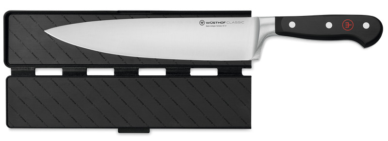 Wide Magnetic Blade Guard securely protecting the blade of a forged German kitchen knife with a polished black handle and rivets.