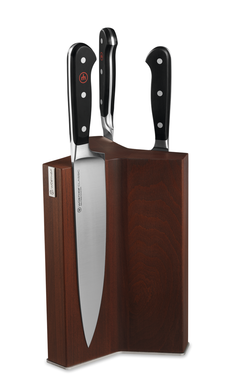 Magnetic Knife Block made of dark wood with three knives featuring black ergonomic handles and polished forged blades for stylish kitchen storage.
