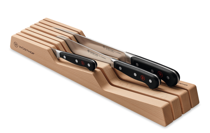 In-Drawer Knife Organizer made from light natural wood, featuring angled slots designed to store and secure forged WÜSTHOF knives with black ergonomic handles.