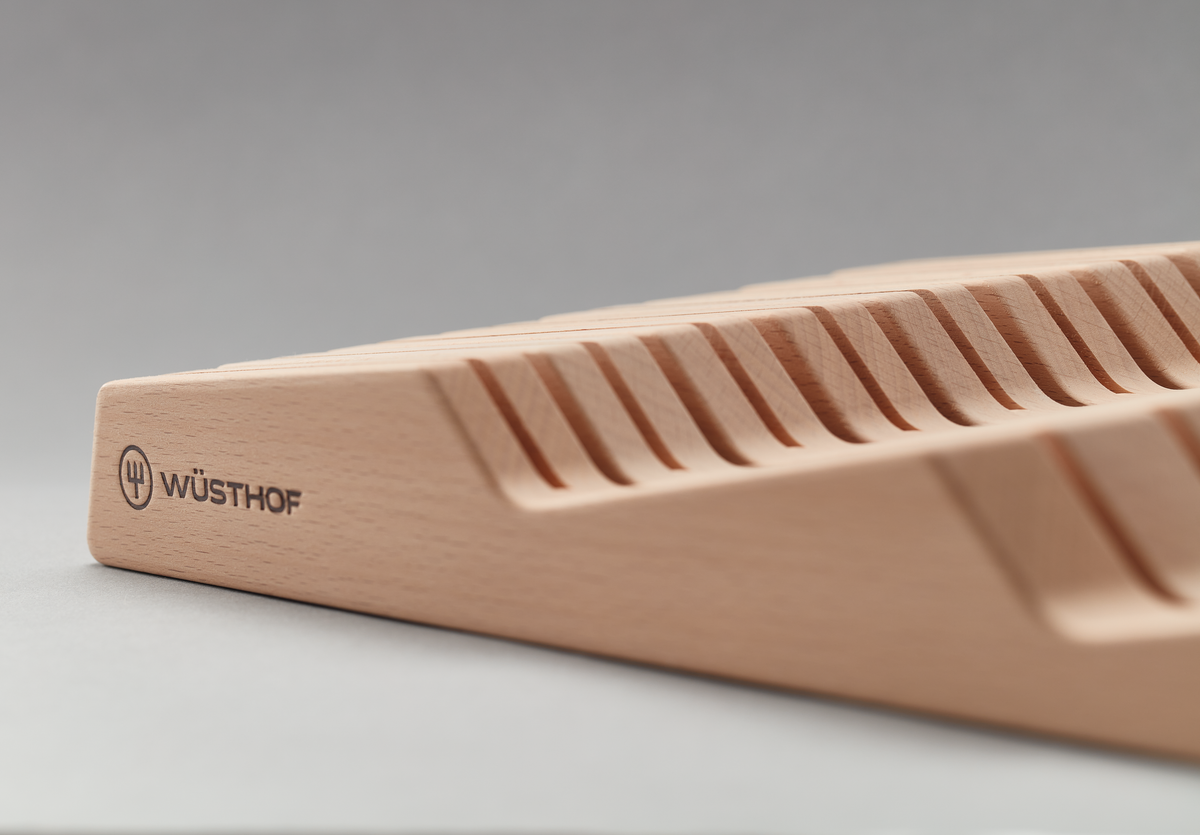 In-Drawer Knife Organizer made from smooth natural wood, featuring angled slots designed to securely hold forged WÜSTHOF kitchen knives.