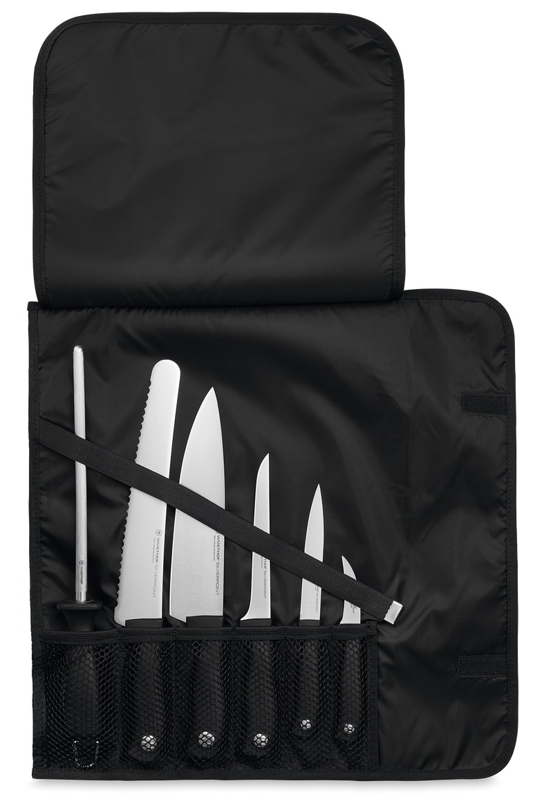 Nylon Knife Roll in black nylon fabric with mesh pockets and strap, holding six assorted forged kitchen knives and a sharpening steel.