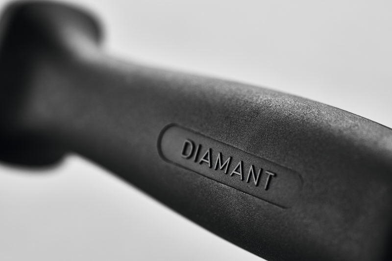 Close-up of the black ergonomic handle of the 10" Diamond Sharpening Steel, Wide, Fine with the word "DIAMANT" embossed on the surface.