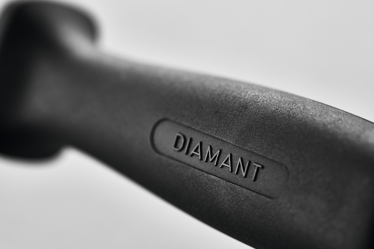 Close-up of the ergonomic black handle of the 10" Diamond Knife Sharpener featuring the embossed word "DIAMANT" for comfortable sharpening of forged kitchen knives.