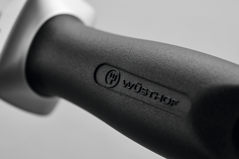 Close-up of the textured black handle embossed with the WÜSTHOF logo on the 10" Ceramic Sharpening Rod J800, highlighting ergonomic design.
