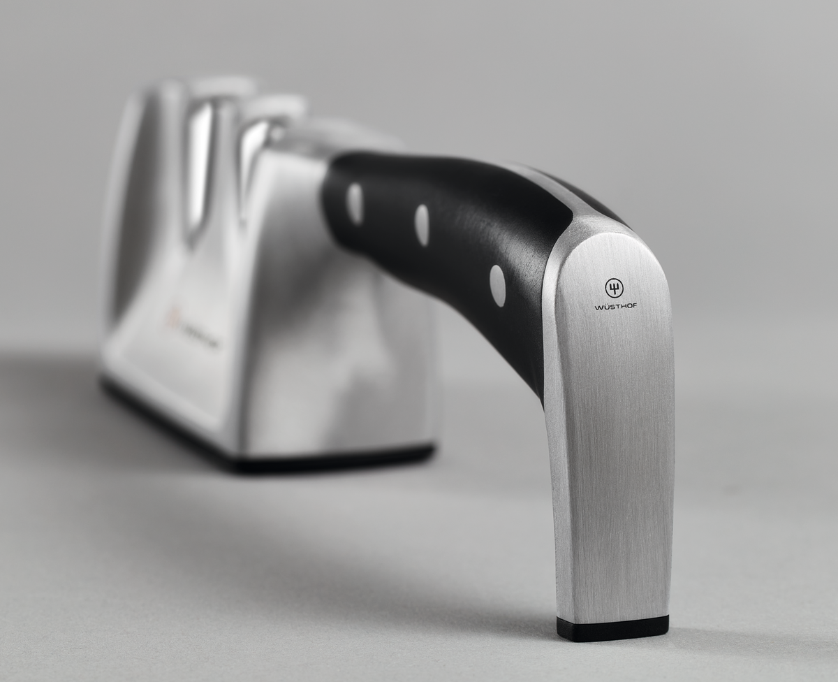 Classic Ikon Hand-Held Knife Sharpener with a brushed stainless steel body and ergonomic black handle designed for sharpening WÜSTHOF forged kitchen knives.