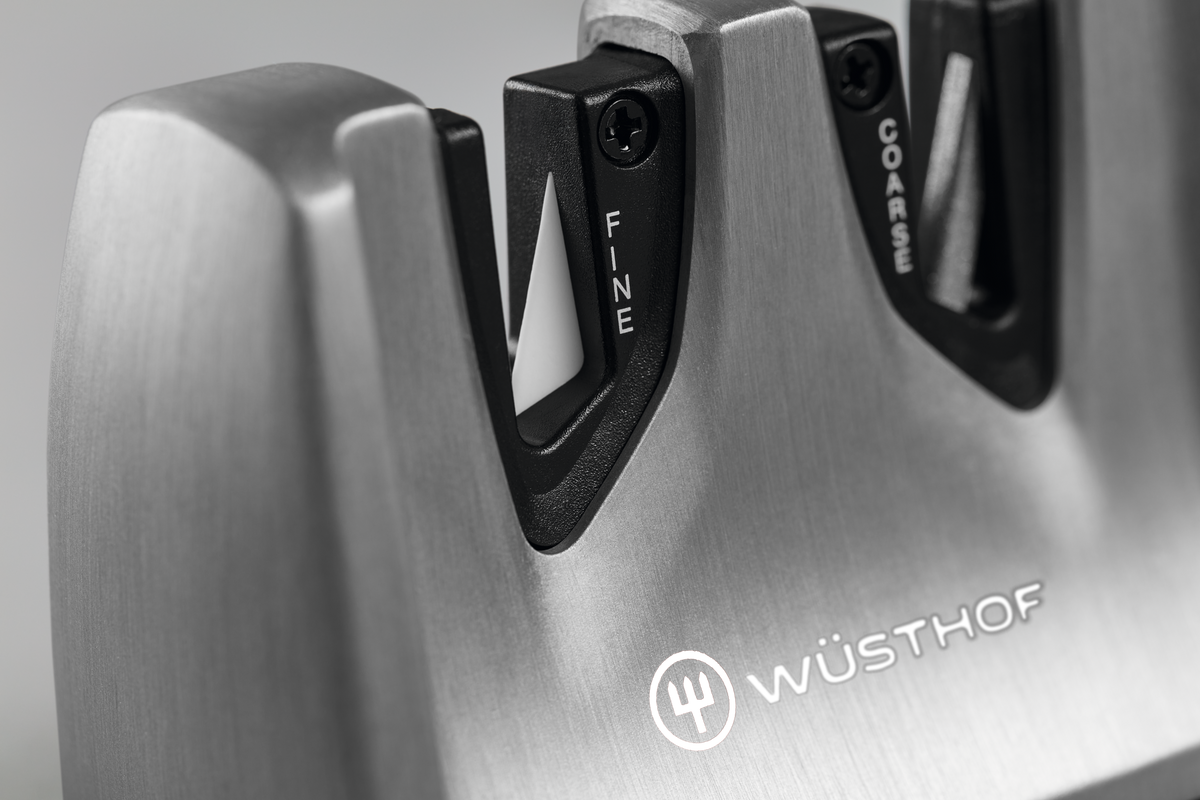 Classic Ikon Hand-Held Knife Sharpener with brushed stainless steel construction featuring fine and coarse sharpening slots designed for WÜSTHOF forged kitchen knives.
