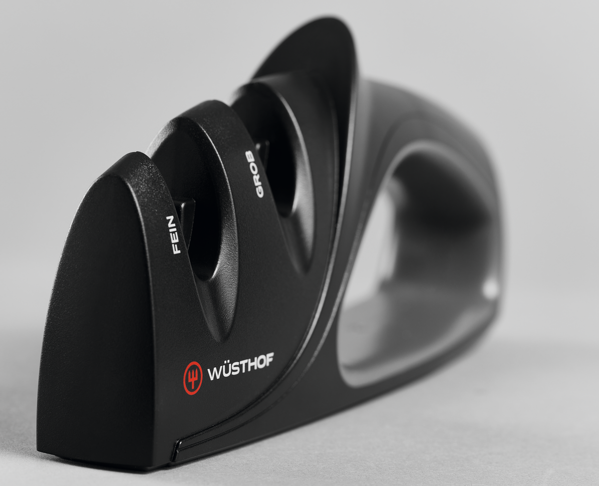 Two-Stage Hand-Held Knife Sharpener with a black ergonomic handle and labeled fine and coarse sharpening slots designed for WÜSTHOF forged kitchen knives.