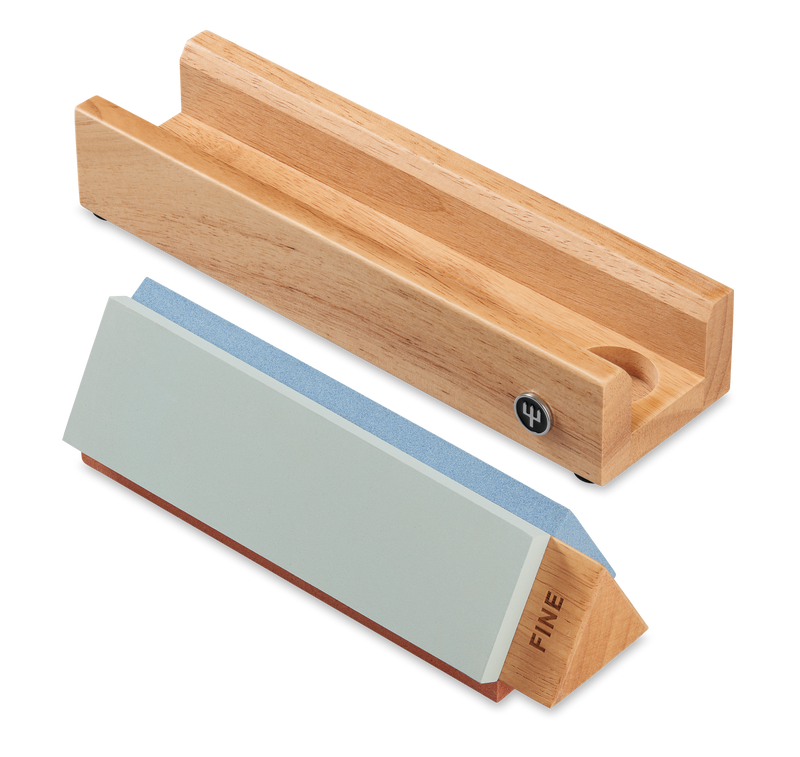 Tri-Stone Knife Sharpener with a wooden base featuring a groove and a detachable sharpening stone labeled fine grit for restoring edge on forged kitchen knives.