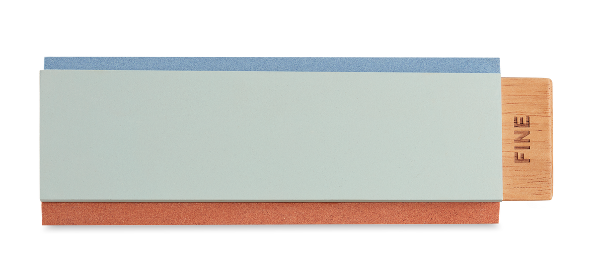Tri-Stone Knife Sharpener featuring a wooden base with a detachable dual-sided sharpening stone for refining the edge of forged kitchen knives.