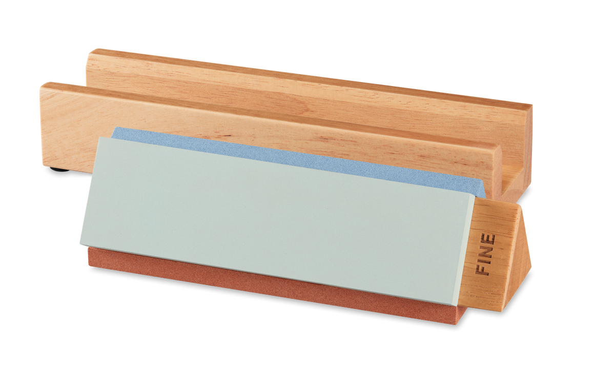 Tri-Stone Knife Sharpener with a wooden base and detachable sharpening stones including a fine grit stone for maintaining sharp edges on German forged kitchen knives.