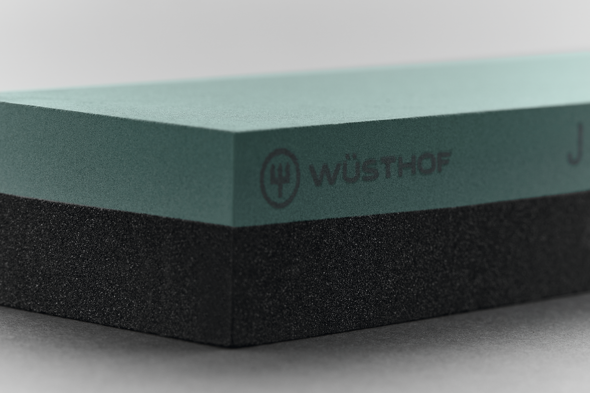 Whetstone J 400 / 2000 with dual grit surfaces in muted teal and black for sharpening and refining edges on Wüsthof forged kitchen knives.