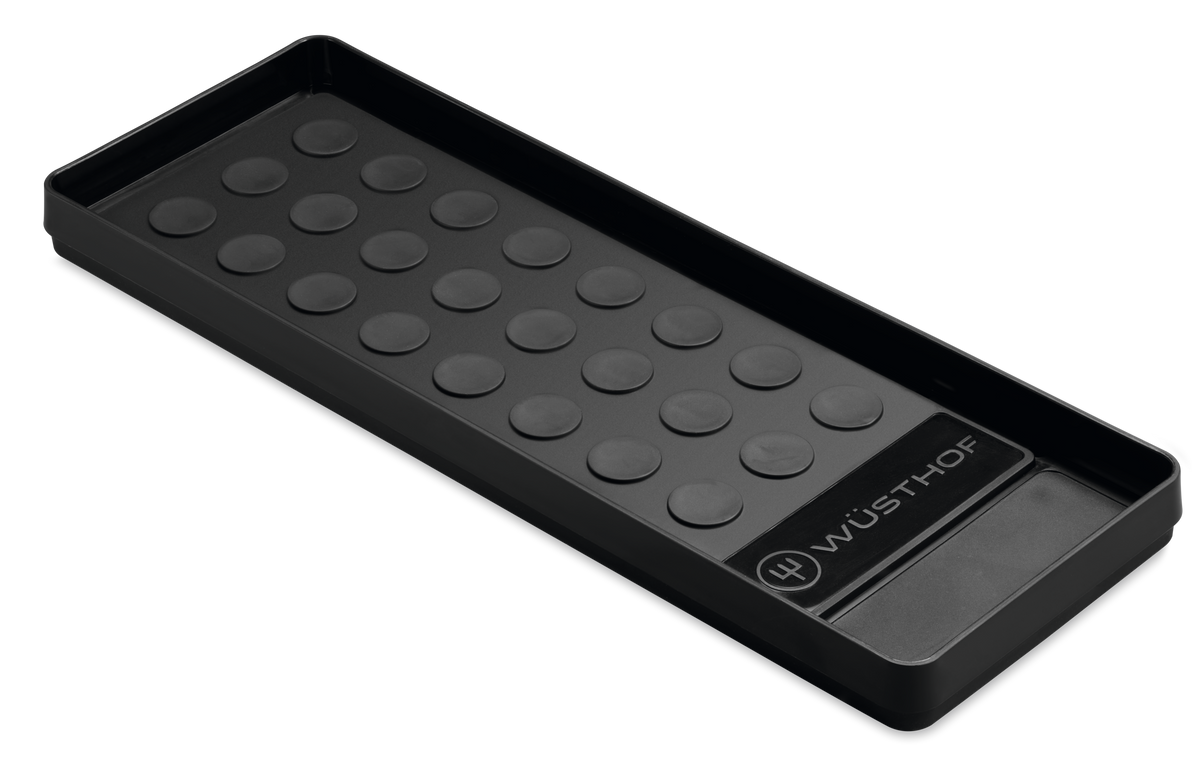 Whetstone Non-slip Holder in black, featuring raised circular grips and WÜSTHOF logo, designed to keep sharpening stones stable during use.