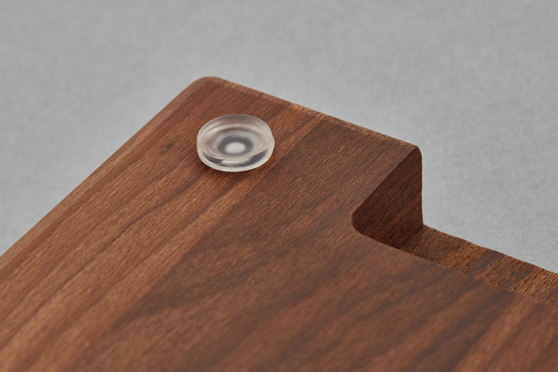 Heat-Treated Beech Cutting Board corner detail showing smooth, rich wood grain and a clear protective non-slip foot for stability during kitchen prep.
