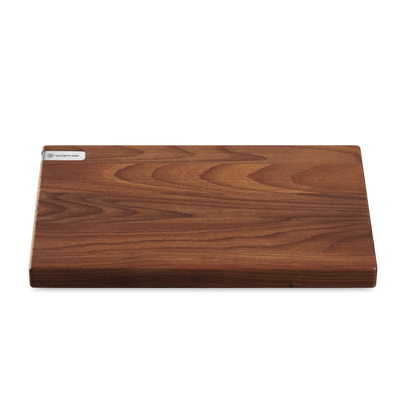Heat-Treated Beech Cutting Board with a rich wood grain surface and a sleek WÜSTHOF metal logo plate for stylish and durable kitchen use.