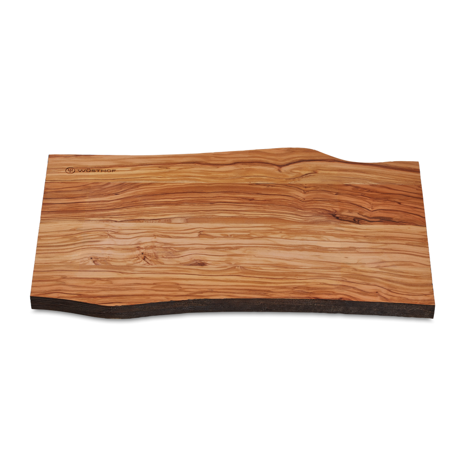 Dune Cutting Board made from olive wood showcasing a natural uneven edge and distinctive grain pattern with a subtle WÜSTHOF logo engraving.