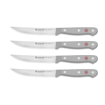 Gourmet 4-Piece Steak Knife Set featuring sharp forged German steel blades with triple-riveted gray ergonomic handles and red logo for balanced control.