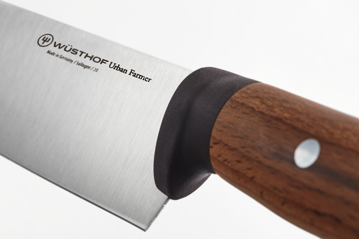 Close-up of the brushed stainless steel blade and polished wooden handle with metal rivet on the Urban Farmer 6" Chef's Knife.