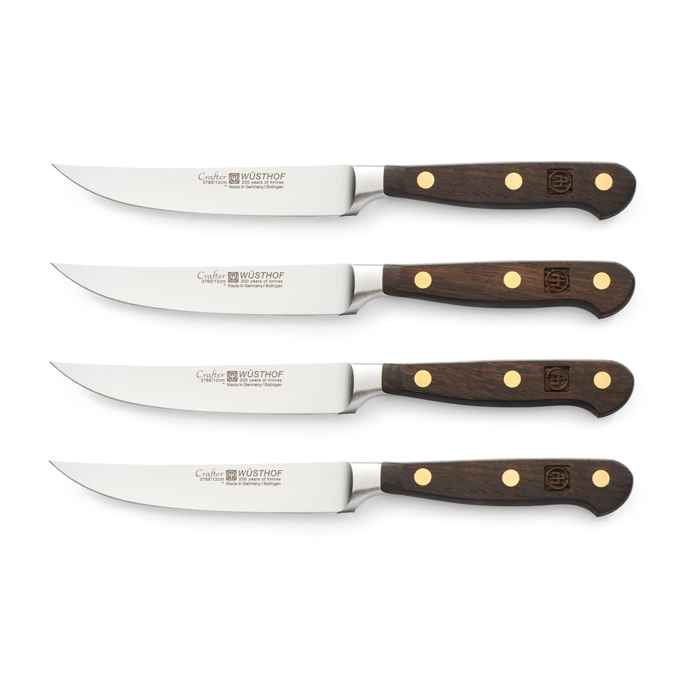 Crafter 4-Piece Steak Knife Set featuring finely forged German steel blades and triple-riveted dark wooden handles for precise and durable steak cutting.