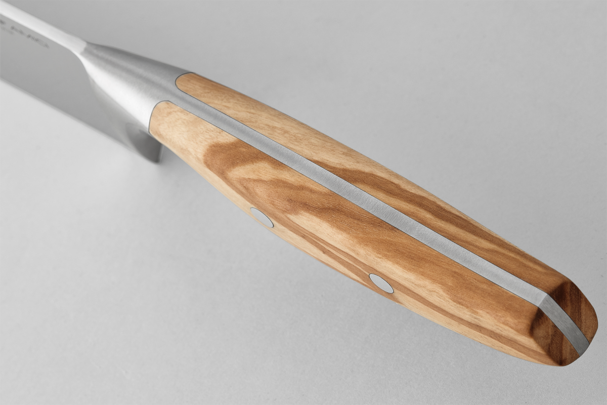 Close-up of the full tang construction and smooth olive wood handle with metal rivets on the "Amici 8" Chef's Knife, highlighting precise craftsmanship.