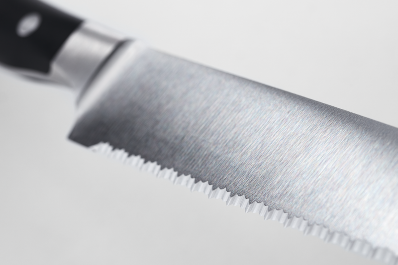 Classic Ikon 9" Precision Double-Serrated Bread Knife with a finely crafted forged German steel blade and a triple-riveted black handle for smooth, precise slicing.