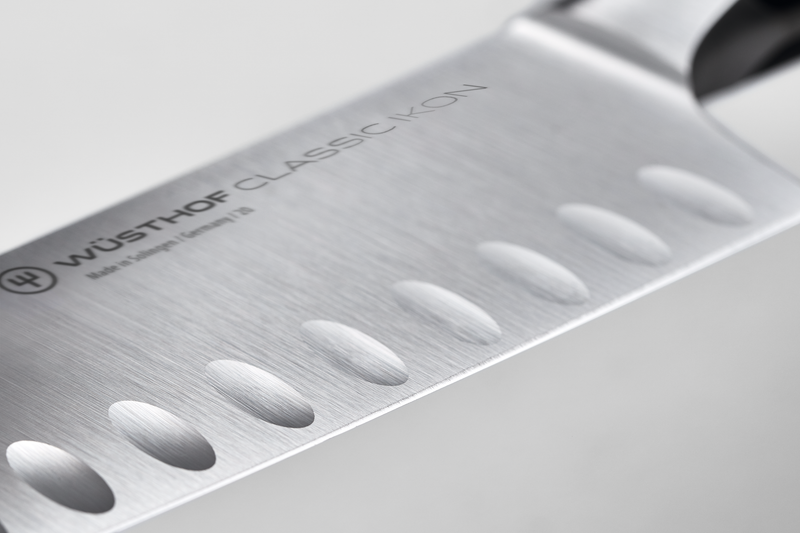 Classic Ikon 5" Hollow Edge Santoku with a forged German steel blade featuring hollowed indentations for reduced food sticking and precise cutting.