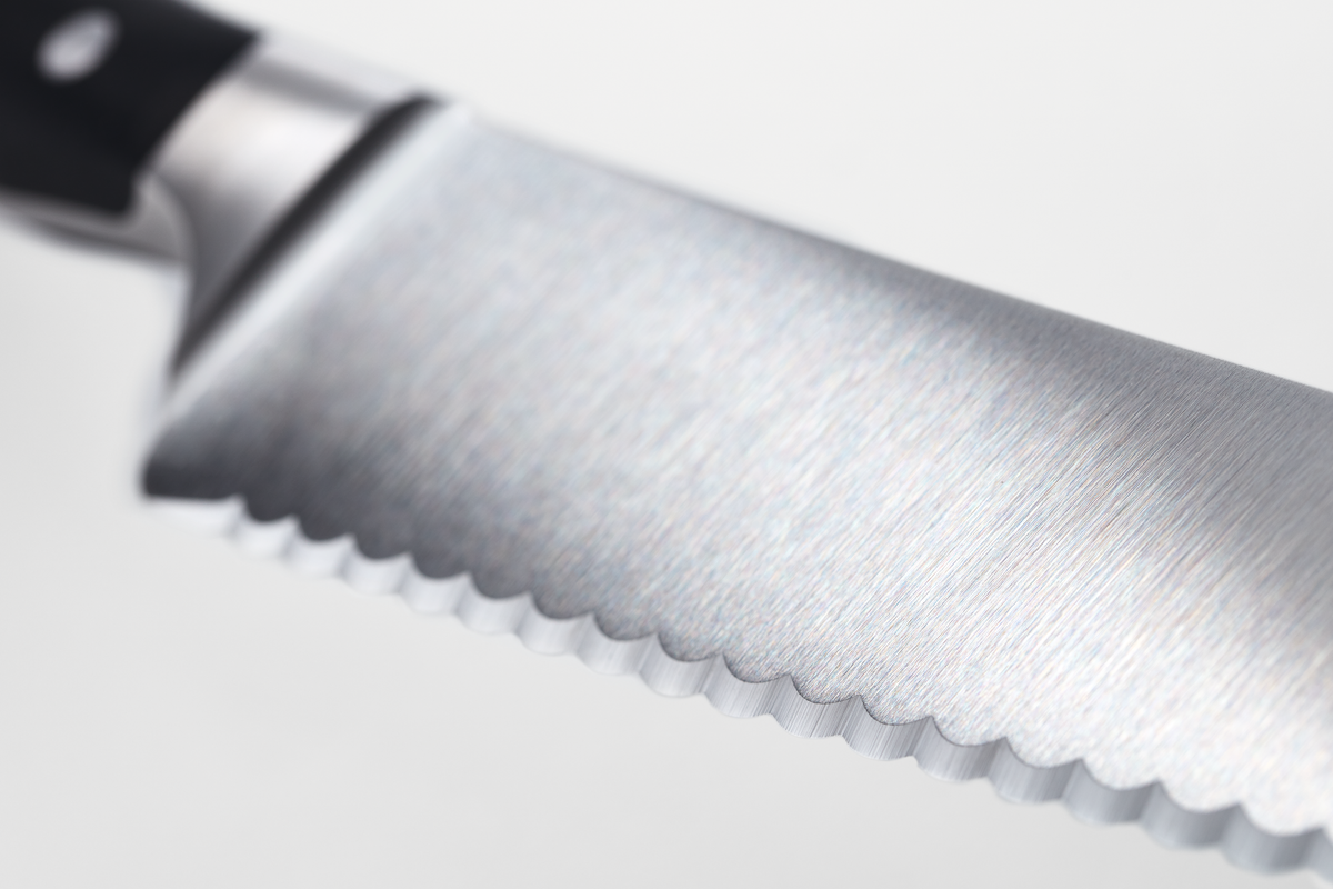 Classic Ikon 10" Super Slicer with a finely serrated, forged German steel blade and ergonomic black handle for precise slicing in the kitchen.