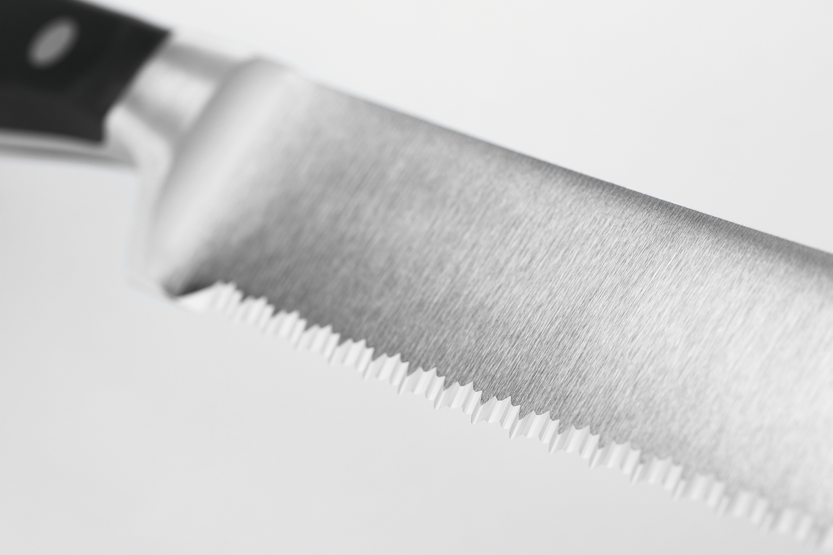 Classic 9" Precision Double-Serrated Bread Knife with a finely crafted forged German steel blade and a black ergonomic handle featuring three rivets.