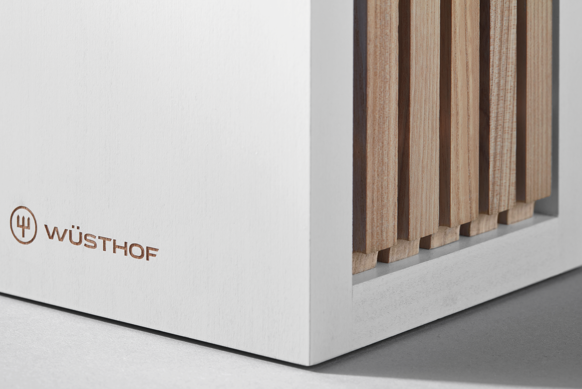 Classic Designer Knife Block showcasing a clean white frame with natural wood vertical slats and the WÜSTHOF logo embossed on the lower corner.