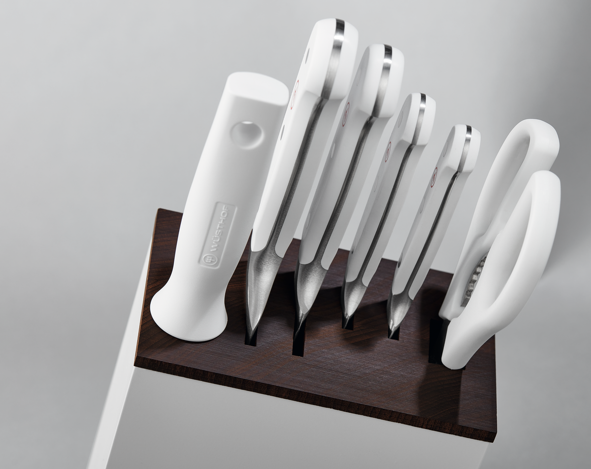 Classic Slim Knife Block displaying a dark wooden top insert holding a set of white-handled forged German knives and sharpening steel neatly arranged.