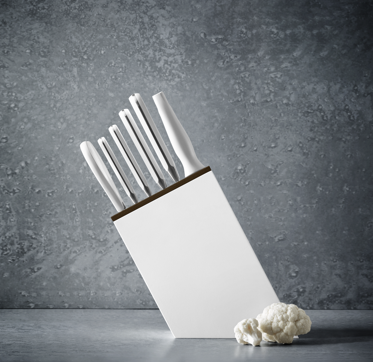 Classic 7-Piece Knife Block Set with Bread Knife featuring all-white ergonomic handles and a sleek white block against a textured gray background.