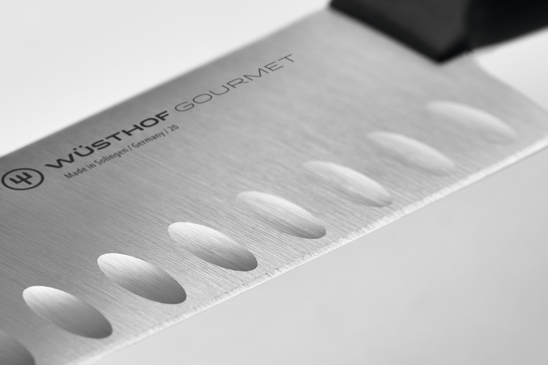 Close-up of the forged stainless steel blade showing hollow edge indentations on the Gourmet 7" Hollow Edge Nakiri for reduced food drag and precise slicing.