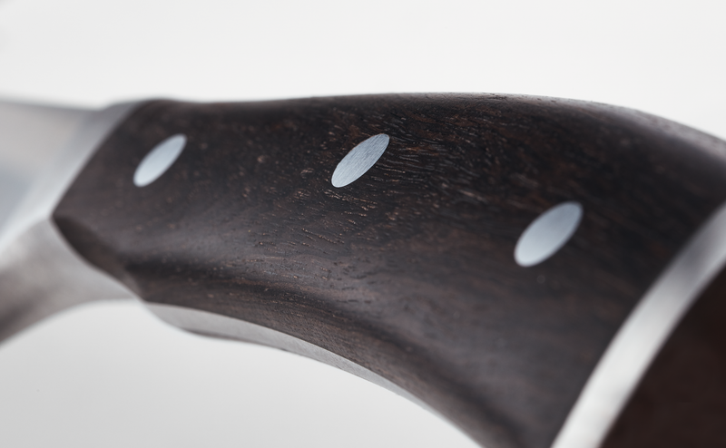 Close-up of the dark wooden handle with three rivets on the Ikon 6" Utility Knife, highlighting its ergonomic design and durable craftsmanship.