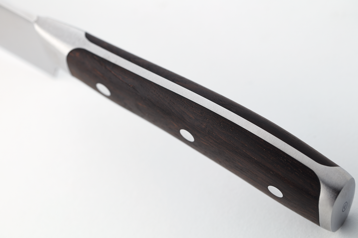 Ikon 6" Utility Knife featuring a sleek forged stainless steel blade with a dark wooden handle secured by three rivets for balanced control and durability.