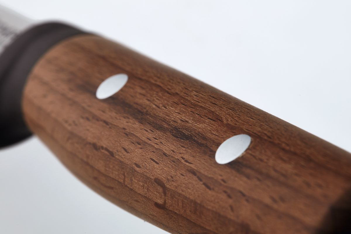 Close-up of the smooth wooden handle with two metal rivets on the Urban Farmer 7" Machete, highlighting quality craftsmanship and durability.