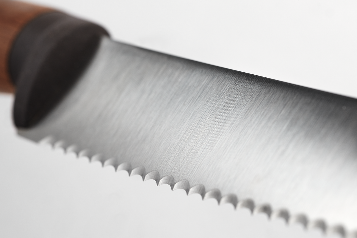 Urban Farmer 9" Bread Knife featuring a serrated stainless steel blade with fine teeth and a polished wooden handle, crafted for precision slicing.