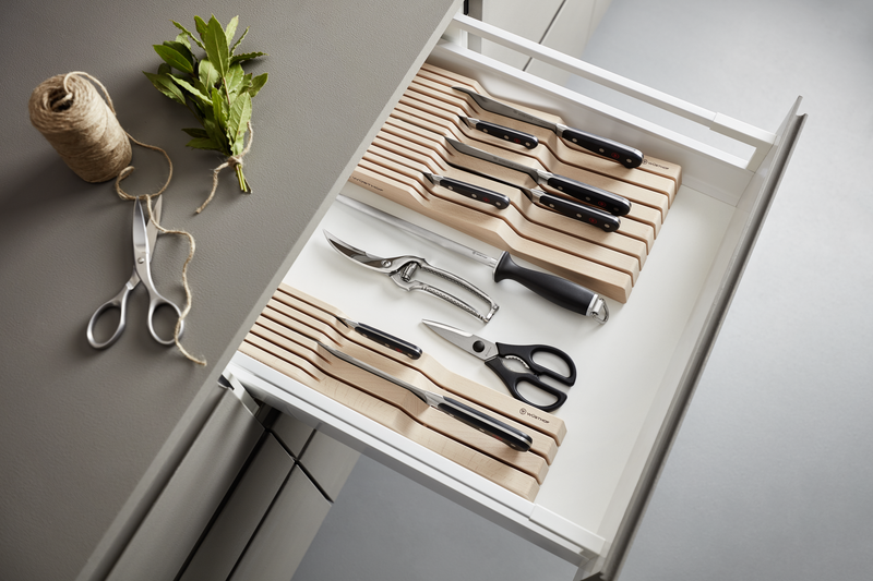 10" Stainless Steel Poultry Shears with textured black handle placed inside a kitchen drawer alongside wooden knife blocks and other cutlery tools for organized storage.
