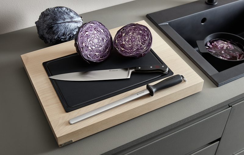 10" Diamond Knife Sharpener with long stainless steel honing rod and ergonomic black handle displayed next to a forged kitchen chef’s knife and halved purple cabbage.